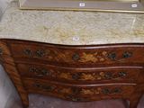 a marble top dresser with a mirror on top of it