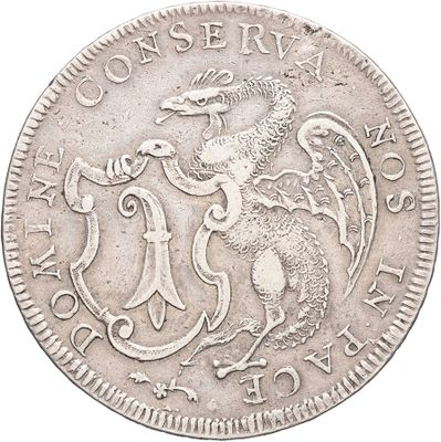 a close up of a silver coin with a dragon on it