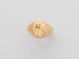 an image of a gold ring with a sun on it