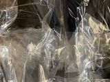 many bags of food wrapped in plastic on a table