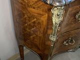 a marble top chest of drawers in the corner of a room