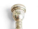 a silver trophy on a white surface with a white background