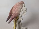 a figurine of a bird perched on a branch