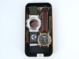a black case with a watch, watch and other items in it