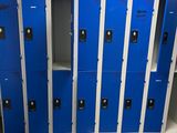 several blue lockers are lined up in a row in a room