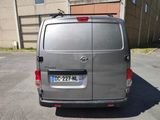 a silver van that is parked in a parking lot