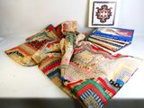 a pile of quilts on a table next to a book