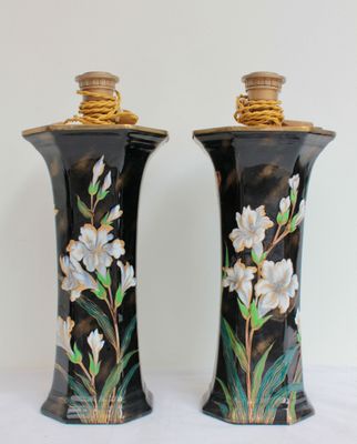 deux vases avec des fleurs peintes dessus, posés sur une table