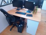 a desk with two computer monitors and a keyboard on it