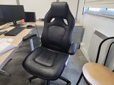 a desk with a chair and a computer on it