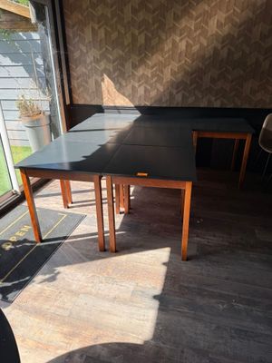 a table and chairs in a room with a large window