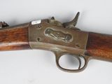 a close up of a rifle on a white surface with a white background
