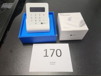 a white calculator and a blue box on a table