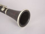 a clarinet that is sitting on a white surface