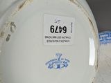 a white and blue bowl and a plate on a table