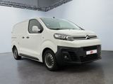 a white van parked inside of a building in a white room