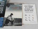 three books are sitting on a table next to each other
