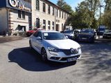 a white car that is parked in front of a building
