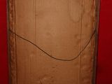 a cardboard box that is sitting in front of a red wall