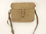 a small tan bag sitting on top of a white surface