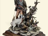 figurine représentant un homme armé d'un pistolet, accompagné d'un chien, assis sur un rocher