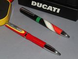 two pens and a pen holder on a table