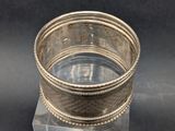 a close up of a silver ring on a clear base