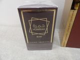 a box of perfume sitting on a table next to a book