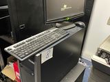 an image of a computer desk with a keyboard and monitor