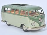 a green and white toy bus that is on a white surface