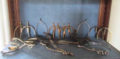 many pairs of scissors on a table in front of a window