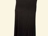 a black dress hanging on a hanger on a white wall