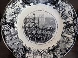 two plates with black and white designs on them on a table