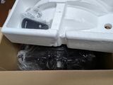 a white sink sitting inside of a box on the floor