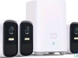 four smart home security cameras sitting next to each other on a white surface