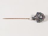 une image représentant une broche en forme de fleur, composée d'un diamant et d'une perle, fixée sur une tige