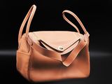 a tan purse with a zipper on the front