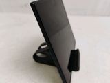a tablet computer sitting on a stand on a table