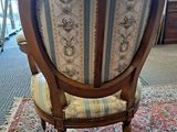 a chair that is sitting on a rug in a room