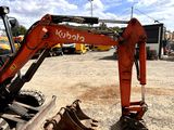 a red excavator that is sitting in the dirt