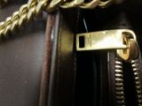 a close up of a purse with a chain on it