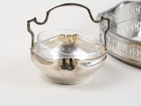 a silver bowl with a handle and a silver bowl with a handle