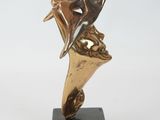 bronze sculpture of a dolphin on a marble base on a white background