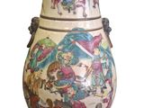 a large vase with a painting on it sitting on a table