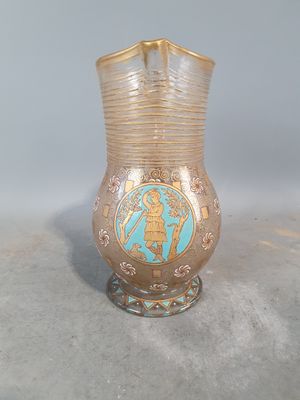 a glass vase with a gold and blue design on it