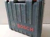 an old bosch tool box sitting on top of a white table