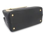 a black purse with gold hardware on the handle