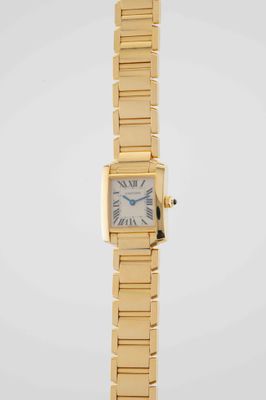 a close up of a gold wrist watch with roman numerals