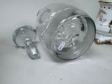 a glass jar and a glass cup sitting on a table