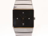 a close up of a watch on a white surface